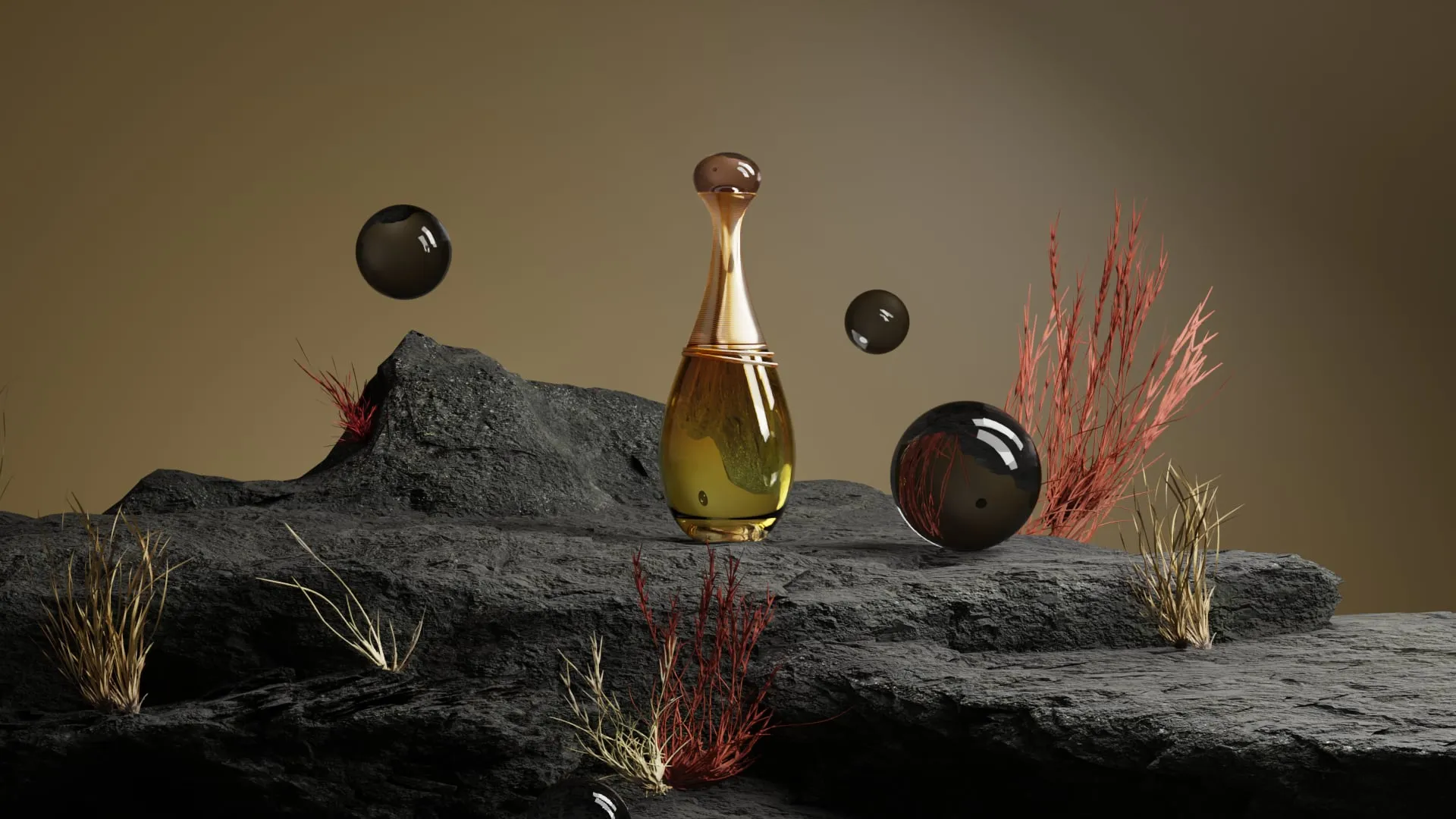 Le flacon doré J'adore posé sur des roches sombres, entouré de sphères de verre noir et d'herbes sèches rouges et jaunes
